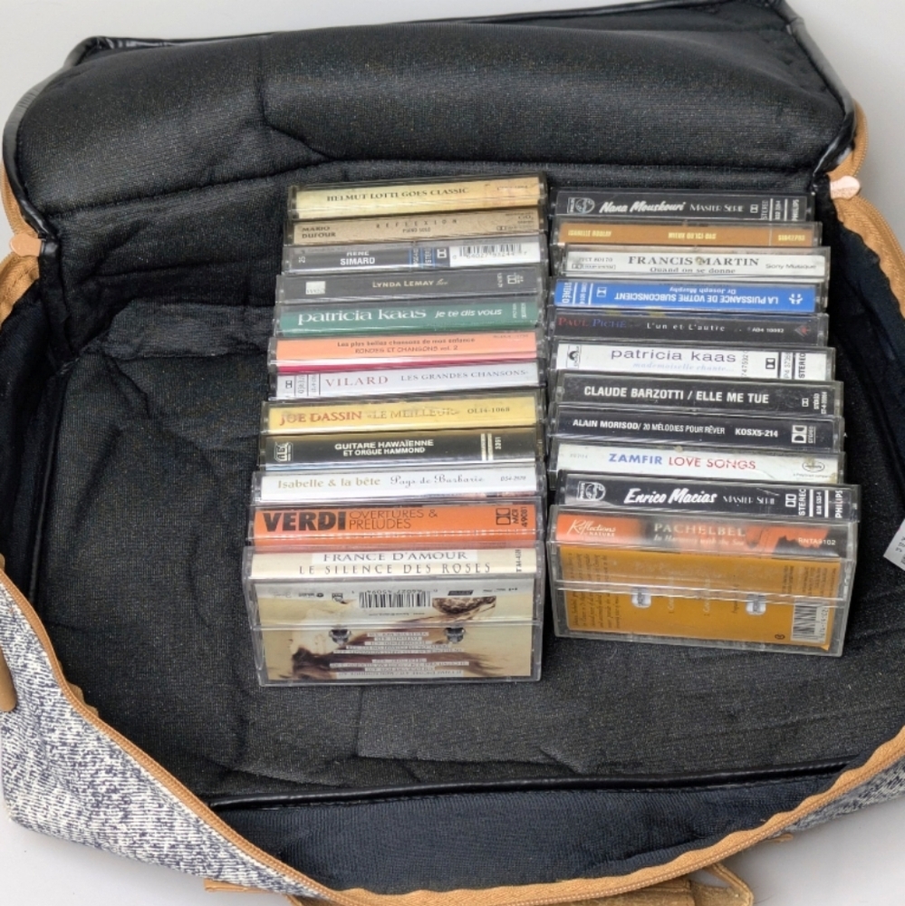 Collection of 23 various french Music Cassette Tapes with travel case.